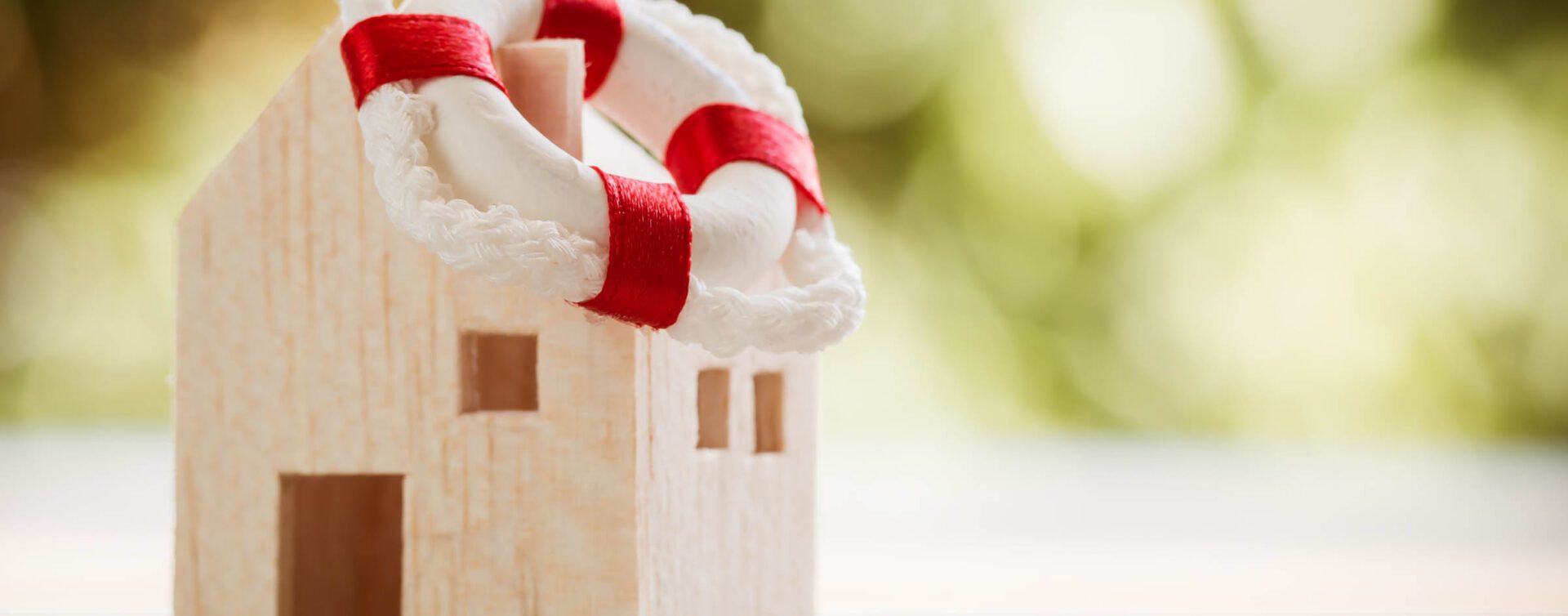 A close up of a white house with red ribbon